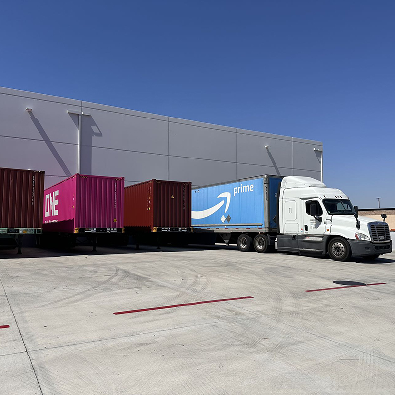 Amazon delivery truck parked at warehouse loading dock