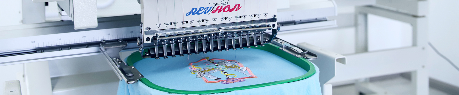 Embroidery machine at work with vibrant design on fabric