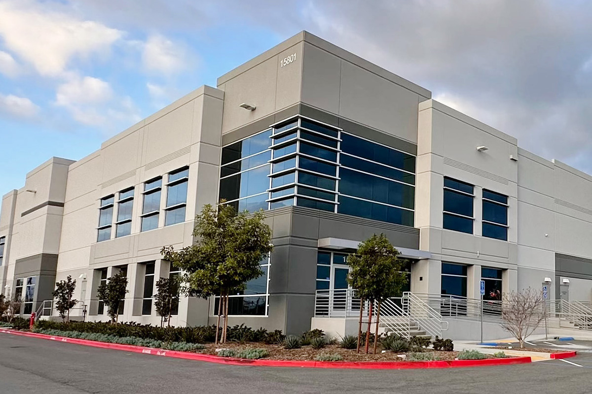 Contemporary office building with large glass windows and landscaped entrance